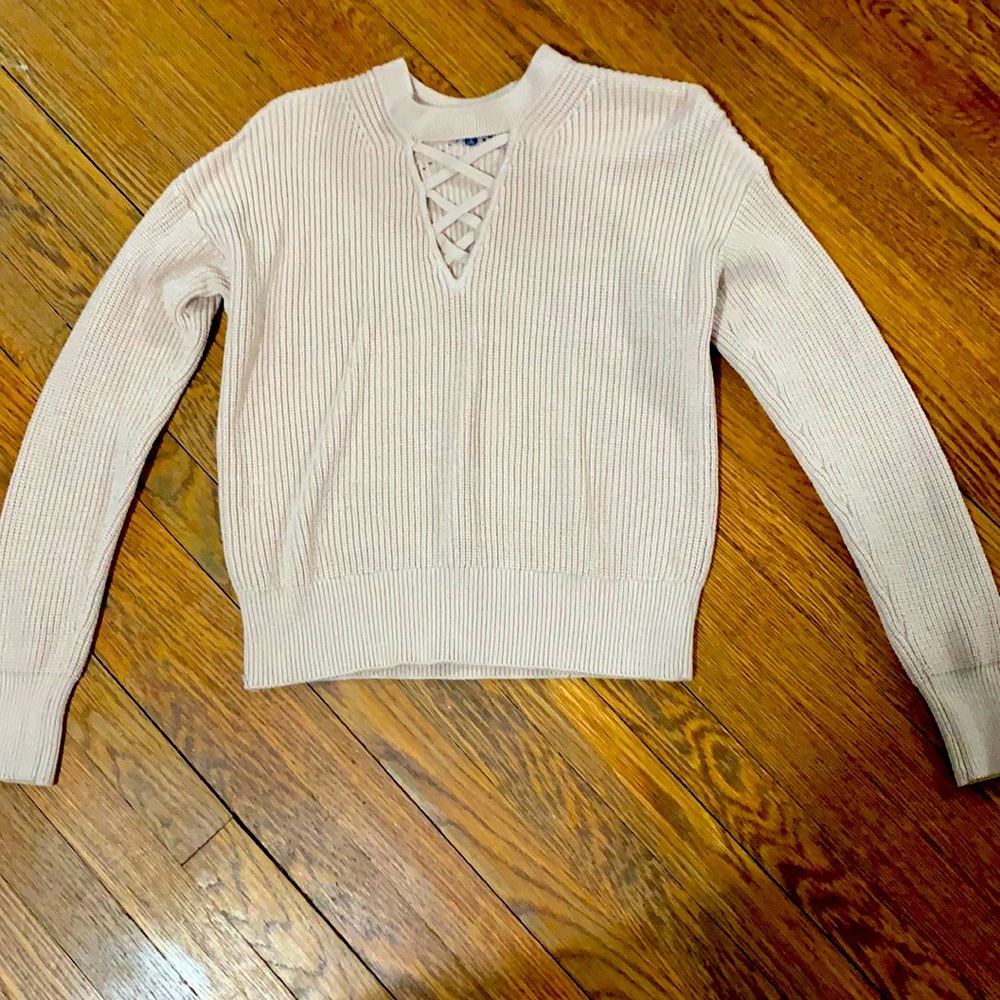 Fashionable pink sweater with cut out in the front.  size small